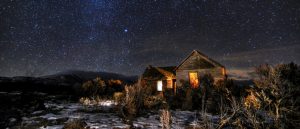 With a flashlight and a few lanterns, this old farm house seems to have company once again underneath clear Idaho skies.