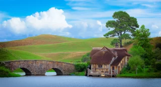 The old hobbit house and rock bridge on the lake, new zealand, use filter, vintage style