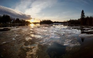 A sunset during springtime across the inlet Baie Moise with ice thawing at Lac Saint-Jean in Alma, Quebec