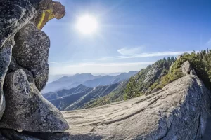 Moro Rock against sun, unique granite dome rock formation in Sequoia National Park, USA.