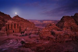 Petra historical sight - Ad Deir Monastery with full moon during the night.