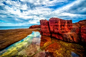 Tura red rocks, situated at Tura headland in the far south coast of NSW Australia these rocks dating over 300 million years form a beautiful backdrop to Tura beach