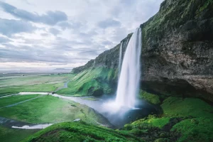 Seljalandsfoss waterfall. Summer landscape with cascade and a river.