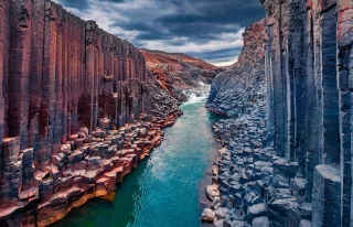 Awesome summer scene of Studlagil Canyon. Stunning morning view ofJokulsa A Bru river.