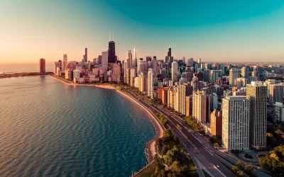 Chicago skyline aerial view with sunrise above downtown buildings and Lake Michigan.