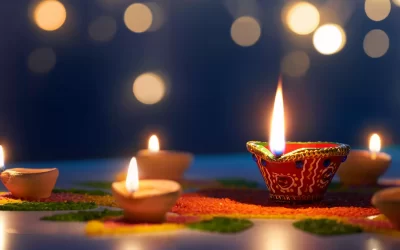 Happy Diwali, Diya lamps lit on colorful rangoli with bokeh light background