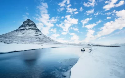 Winter landscape with rising sun on Kirkjufellsfoss waterfall and Kirkjufell mountain, Iceland, Europe.