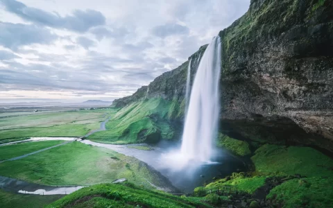 Seljalandsfoss waterfall. Summer landscape with cascade and a river.