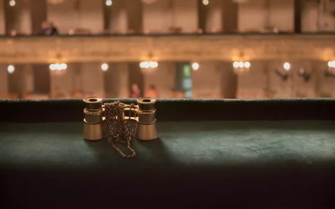 Opera concept. Opera glasses in concert hall