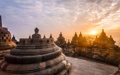 The Borobudur temple with the buddha at morning during sunrise.