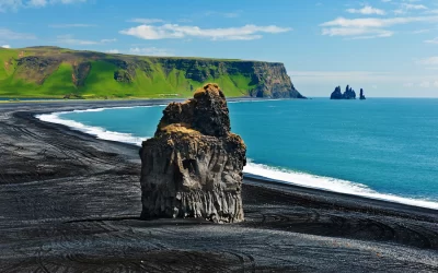 Beautiful rock formation on a black volcanic beach at Cape Dyrholaey, the most southern point of Iceland.