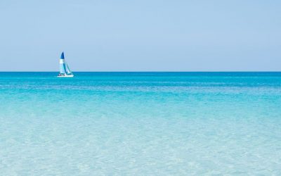Sailboat sails alone in the Caribbean sea near the coast, wonderful colors  turquoise, blue, azure of the sea.sunny day Varadero Cuba.