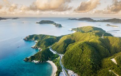 An aerial view over islands with beautiful water and reef surrounding them. From the Kerama island chain in Okinawa, Japan.