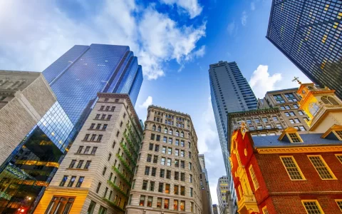 Sunset view of Boston buildings from city street, Massachusetts, USA.