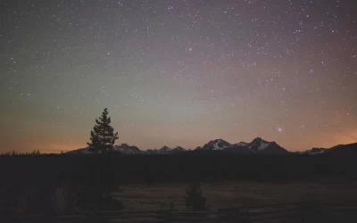 Stars and colored night sky over mountains near Stanley, Idaho, USA.
